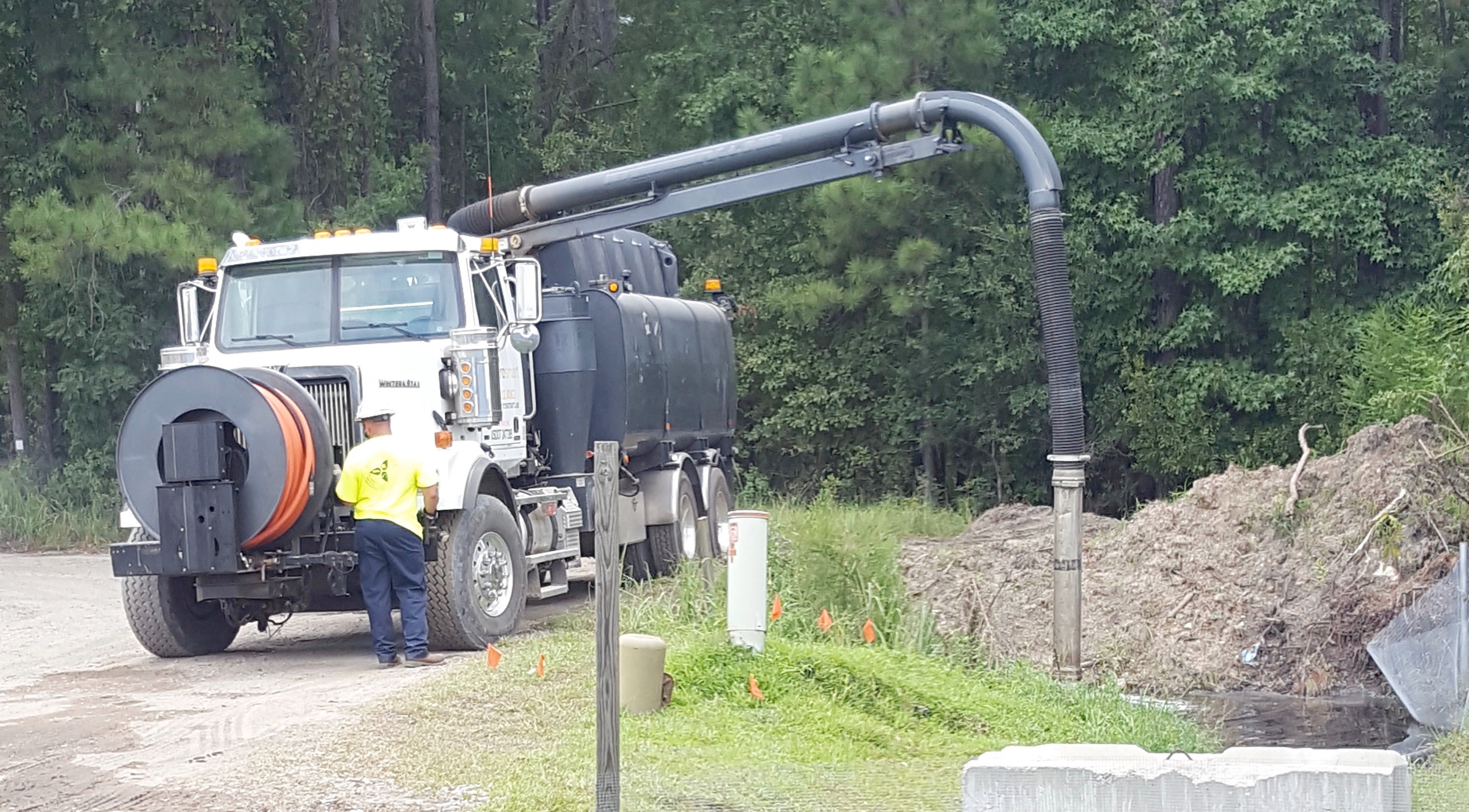 Large truck releasing water from pipe